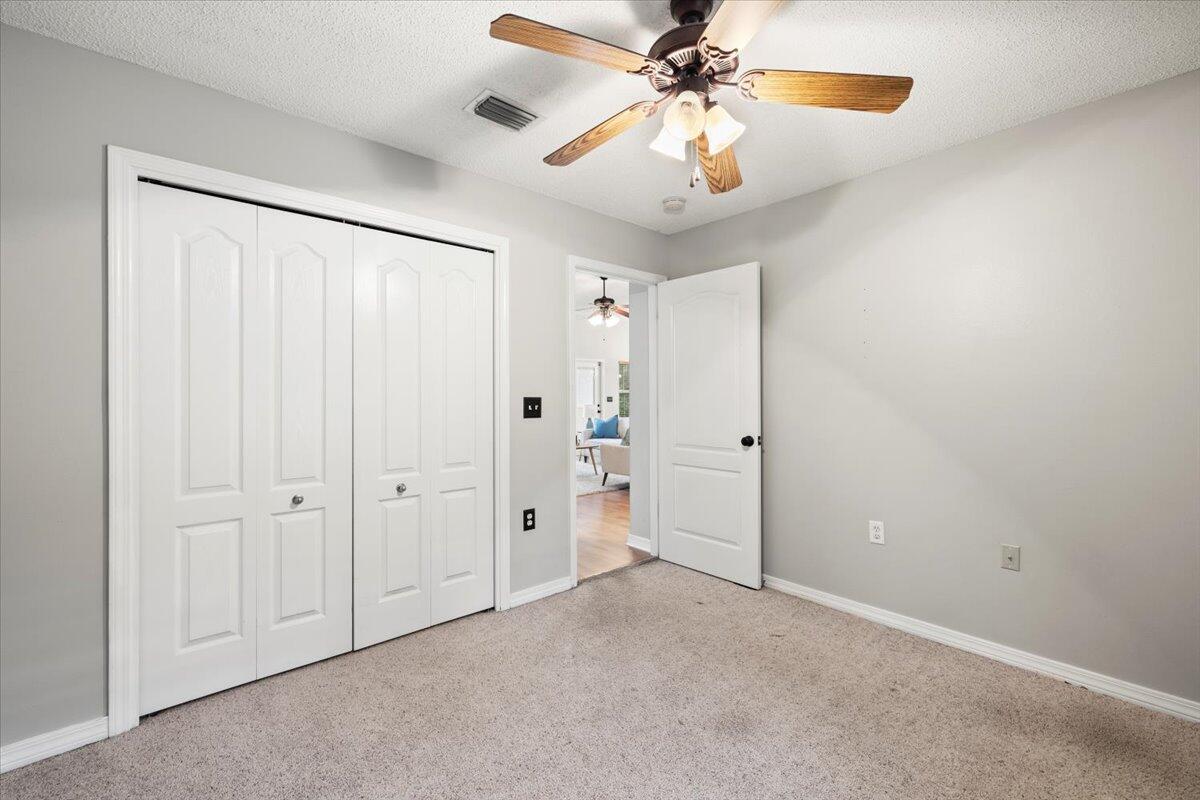 3140 Skyline Drive Crestview, FL 32539 - Photo 9 of 29 an empty room with closet and a chandelier fan