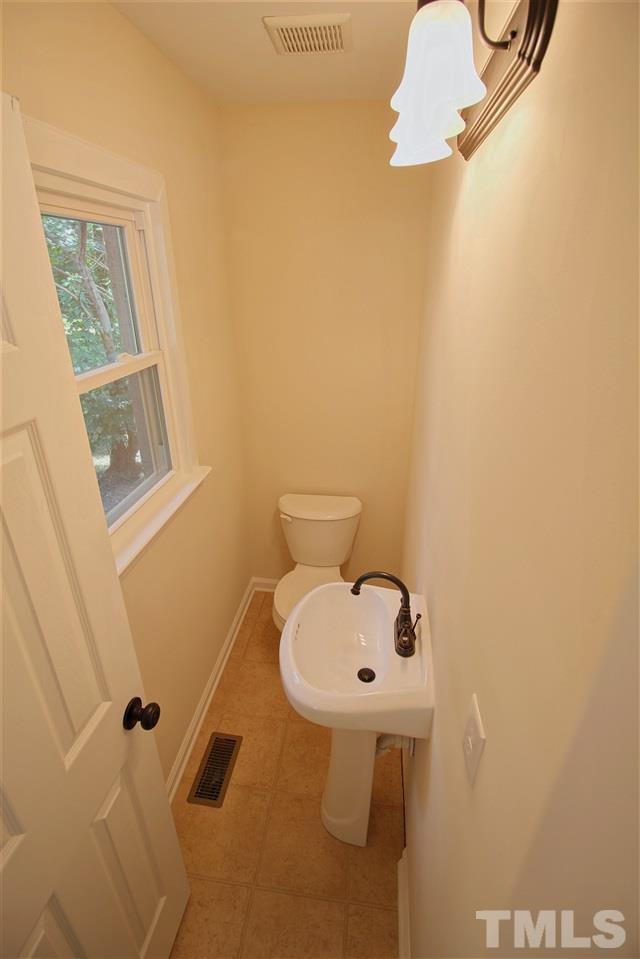 516 Dacian Road Raleigh, NC 27610 - Photo 13 of 16 a bathroom with a sink mirror and toilet