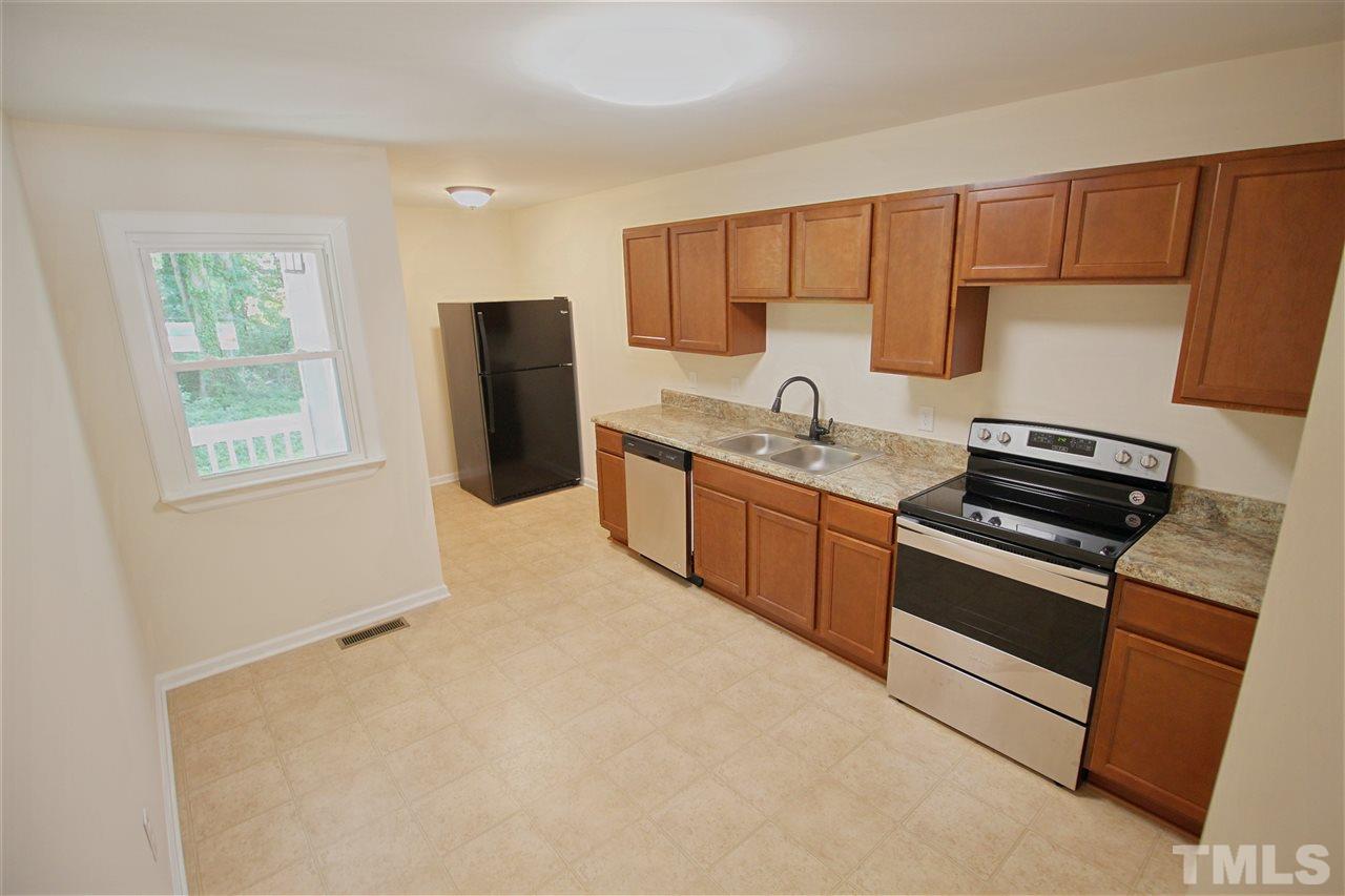 516 Dacian Road Raleigh, NC 27610 - Photo 5 of 16 a kitchen with stainless steel appliances granite countertop a refrigerator stove and sink