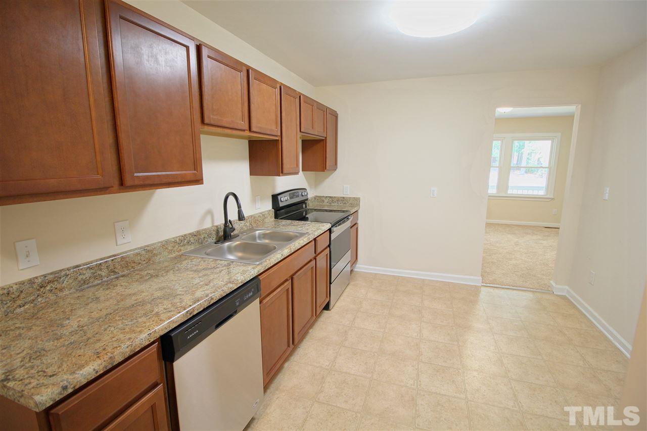 516 Dacian Road Raleigh, NC 27610 - Photo 6 of 16 a kitchen with granite countertop a sink and cabinets