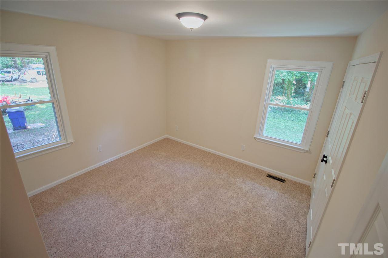 516 Dacian Road Raleigh, NC 27610 - Photo 8 of 16 an empty room with windows