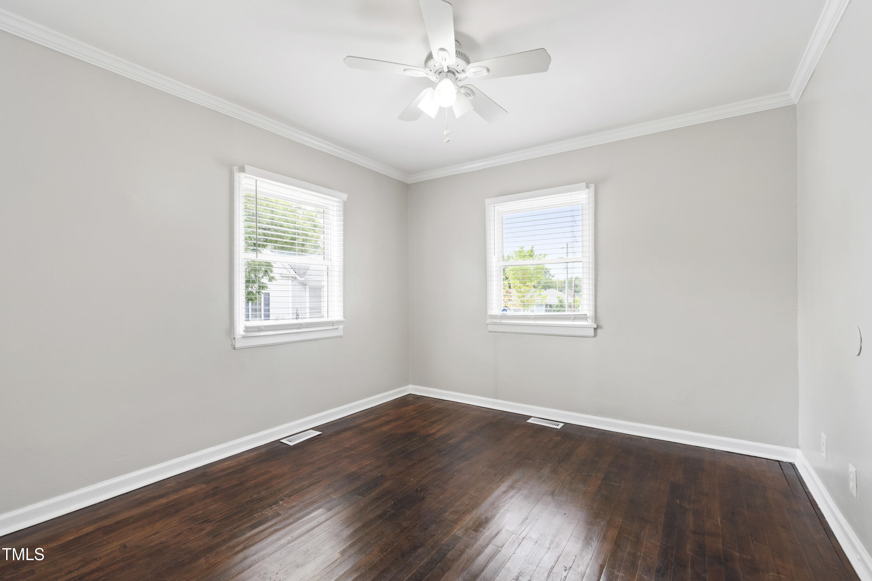 1220 Garner Road Raleigh, NC 27610 - Photo 11 of 26 a view of an empty room with wooden floor and a window