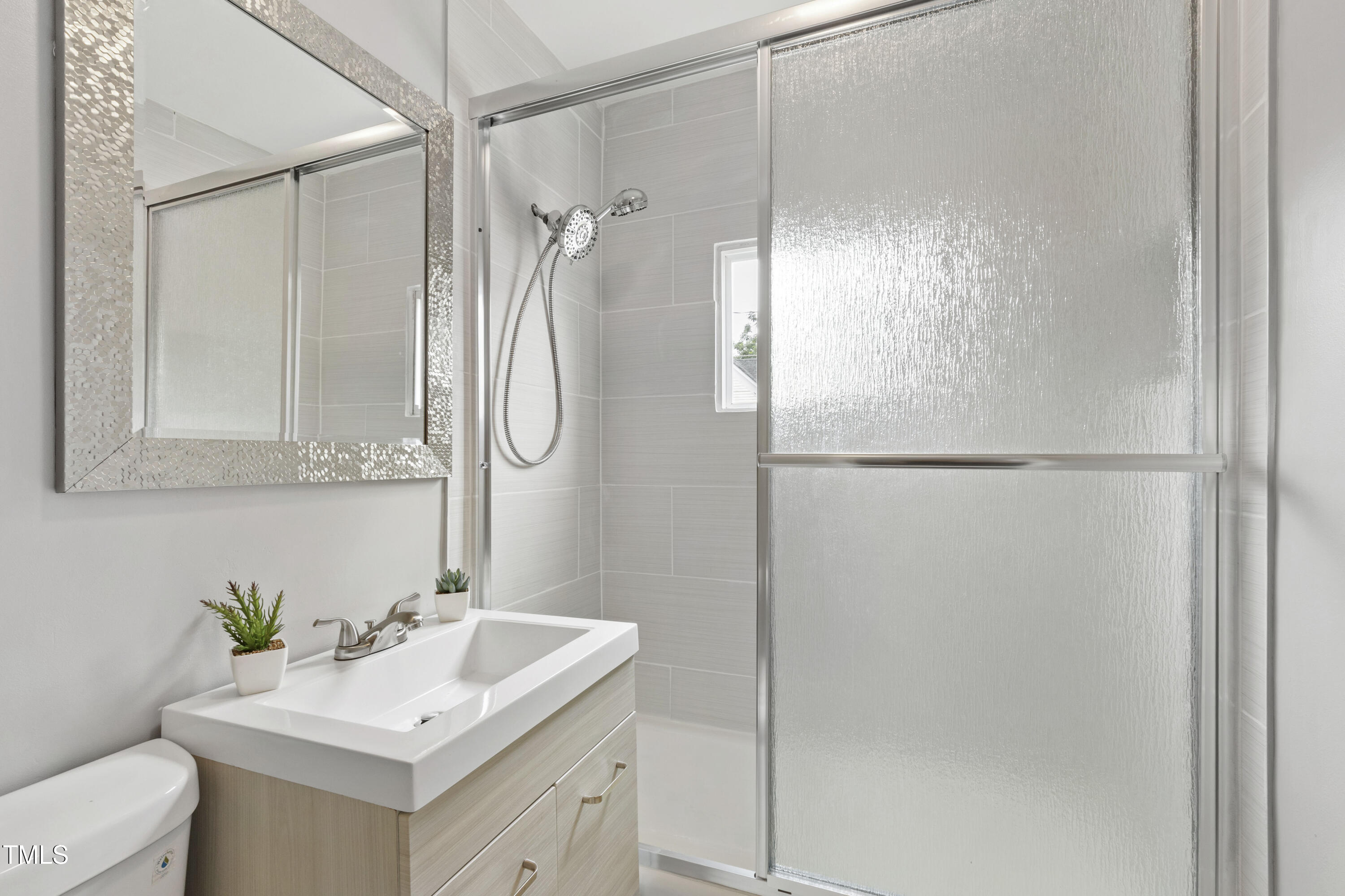 1220 Garner Road Raleigh, NC 27610 - Photo 13 of 26 a bathroom with a sink vanity mirror and shower