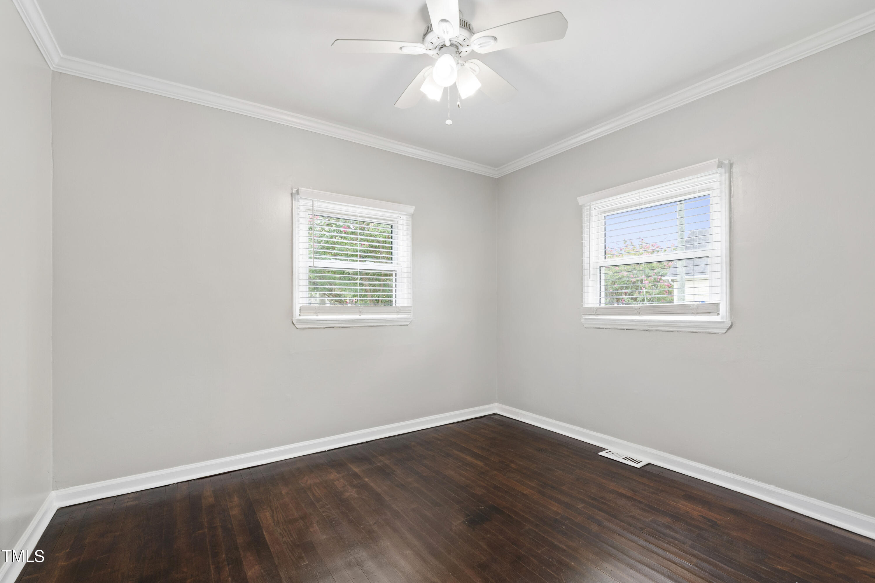 1220 Garner Road Raleigh, NC 27610 - Photo 15 of 26 a view of an empty room with wooden floor and a window