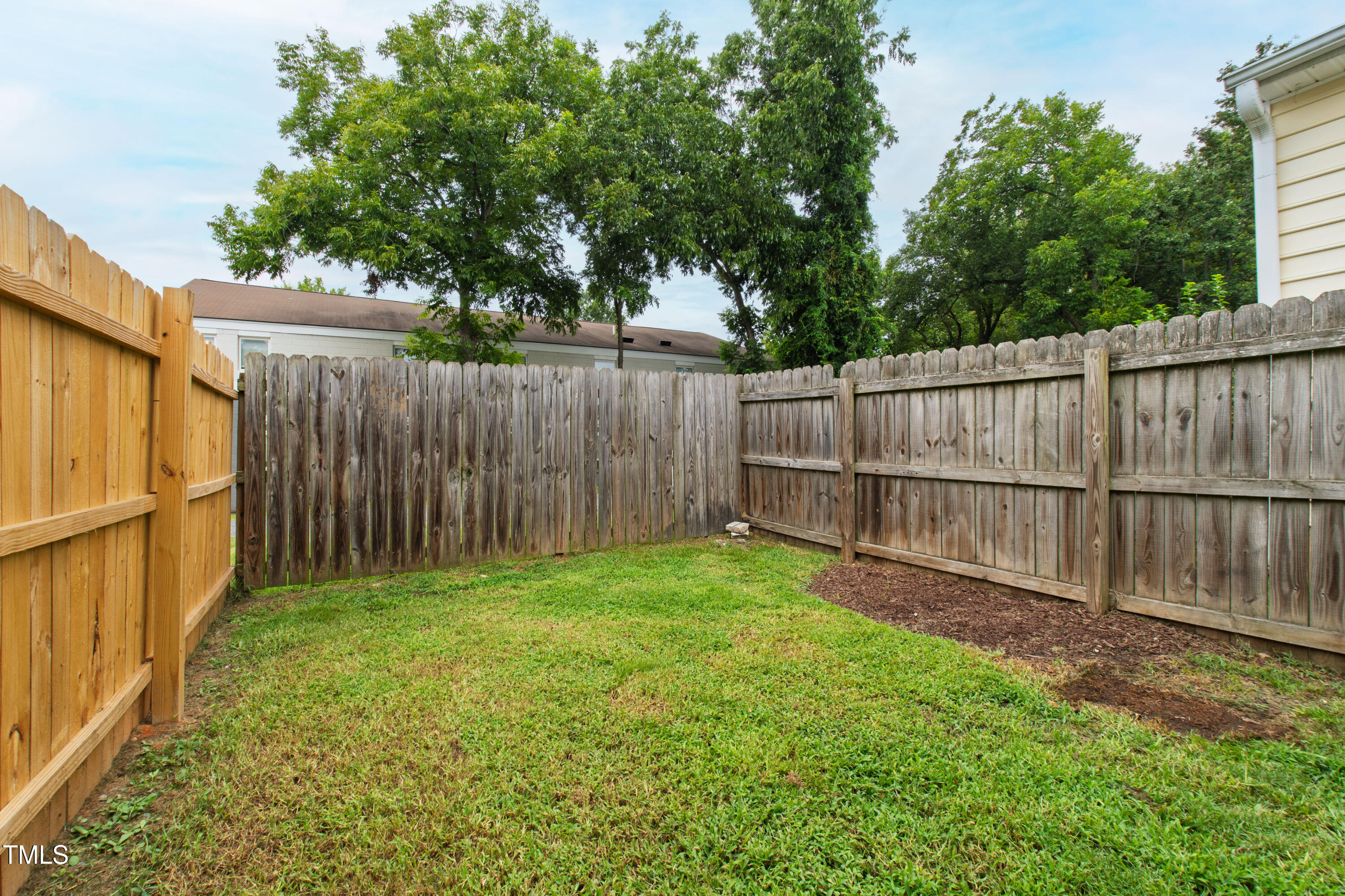 1220 Garner Road Raleigh, NC 27610 - Photo 19 of 26 a view of a backyard with wooden fence