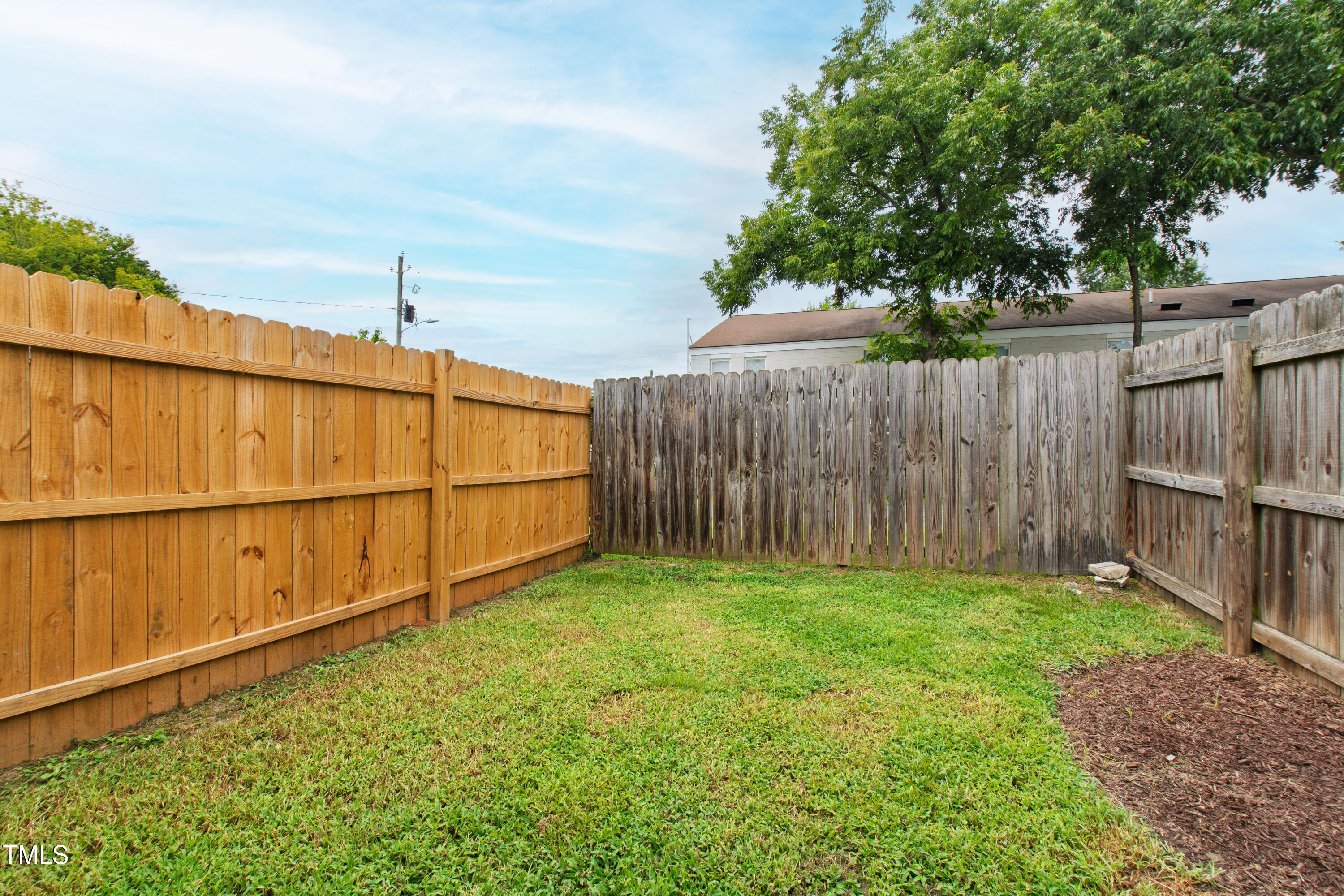 1220 Garner Road Raleigh, NC 27610 - Photo 20 of 26 a view of a backyard with wooden fence