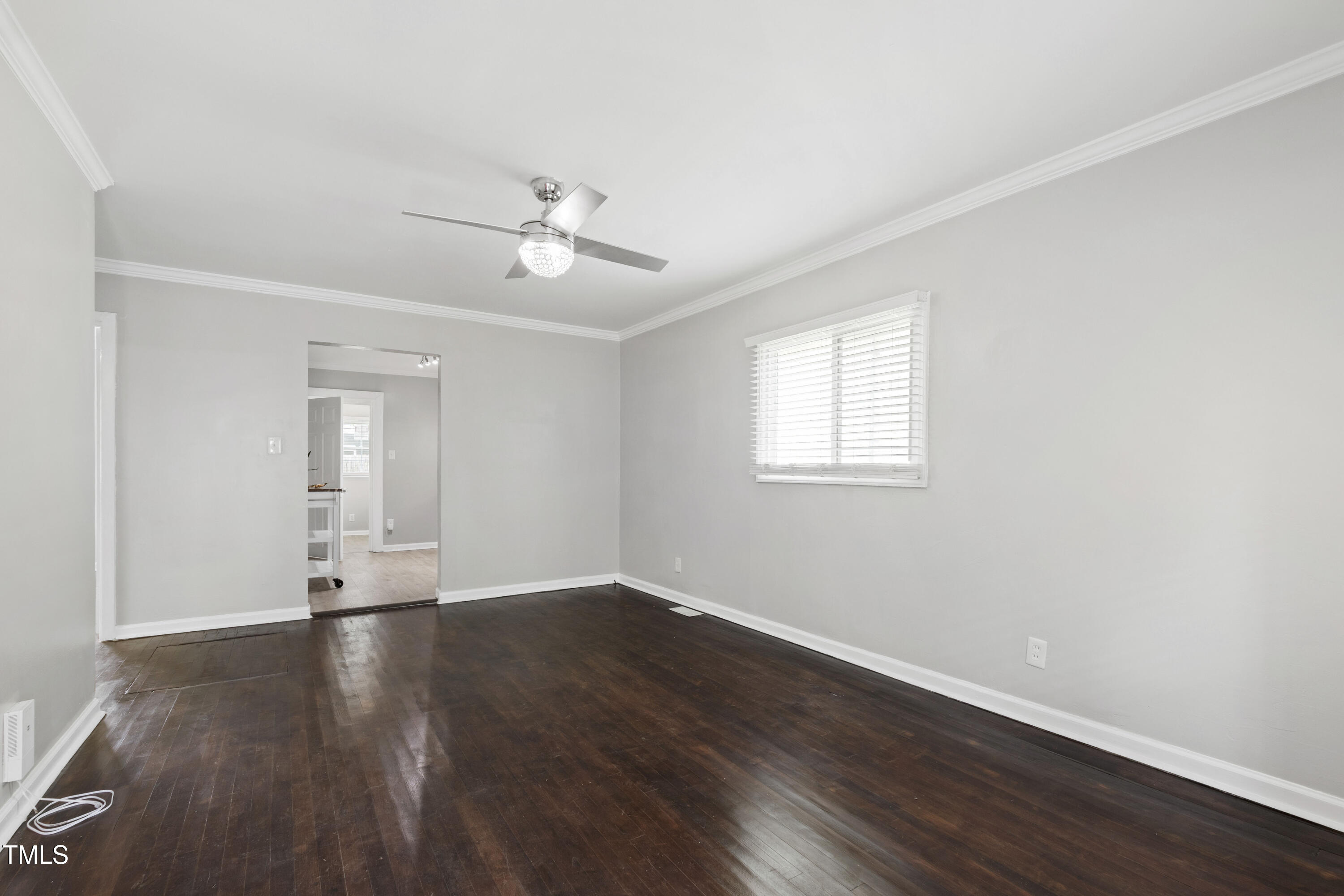 1220 Garner Road Raleigh, NC 27610 - Photo 5 of 26 a view of an empty room with wooden floor and a window