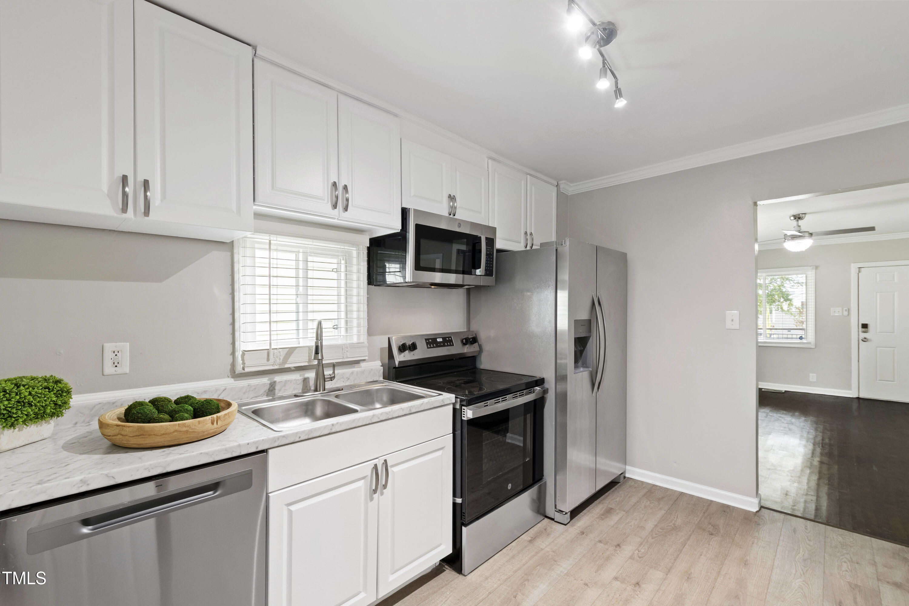 1220 Garner Road Raleigh, NC 27610 - Photo 9 of 26 a kitchen with granite countertop a sink and steel appliances