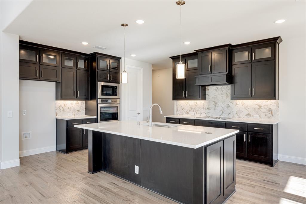5622 Rowlan Row Midlothian, TX 76065 - Photo 11 of 35 a kitchen with stainless steel appliances granite countertop a sink stove and refrigerator