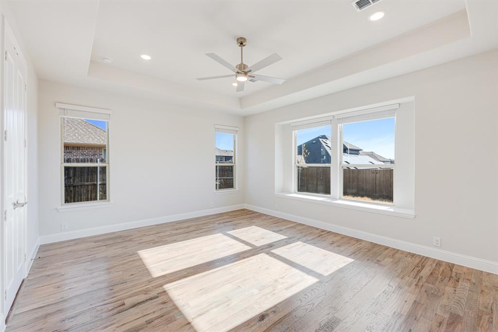 5622 Rowlan Row Midlothian, TX 76065 - Photo 15 of 35 a view of an empty room with a window and wooden floor
