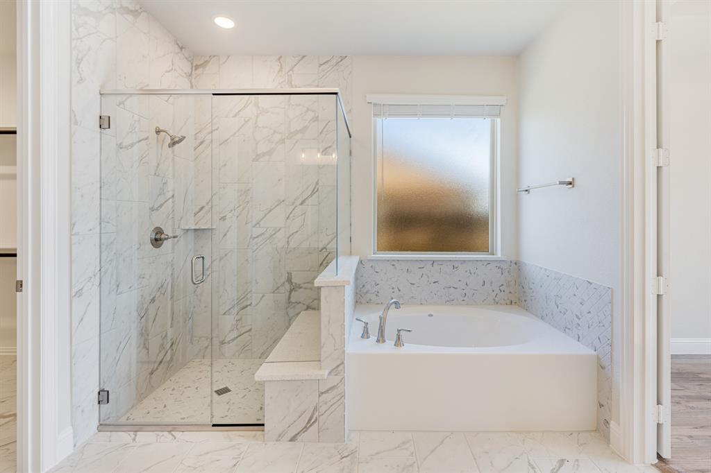 5622 Rowlan Row Midlothian, TX 76065 - Photo 18 of 35 a white bath tub sitting next to a shower
