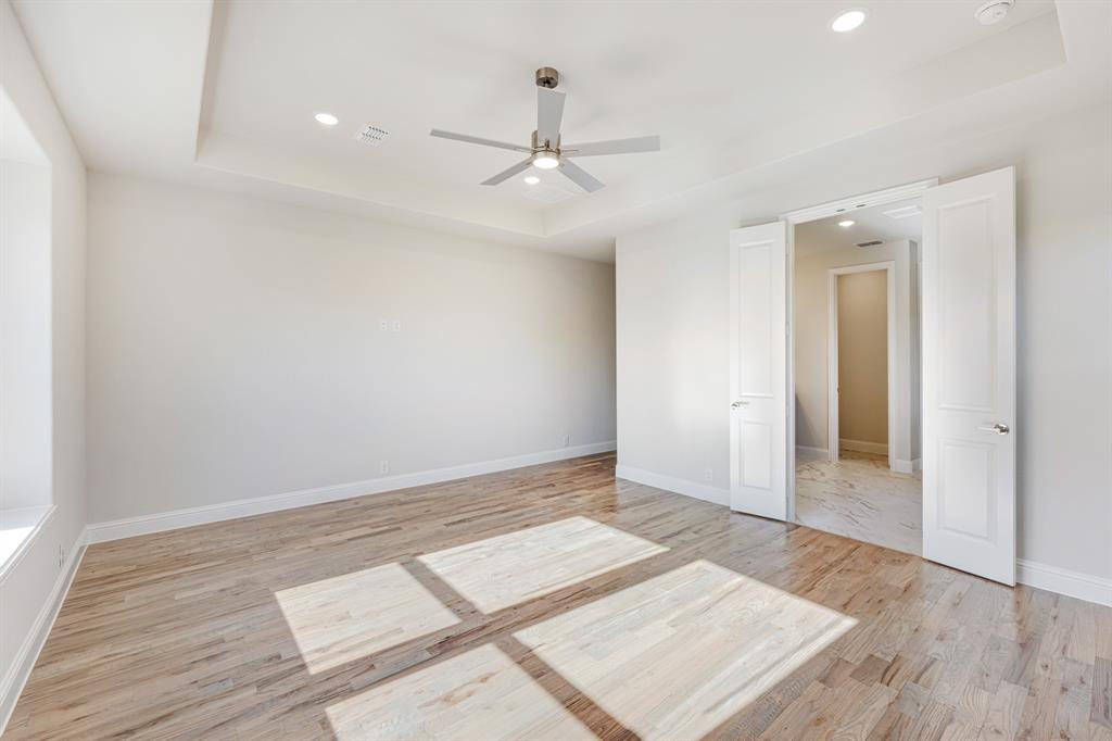 5622 Rowlan Row Midlothian, TX 76065 - Photo 19 of 39 an empty room with wooden floor ceiling fan and windows