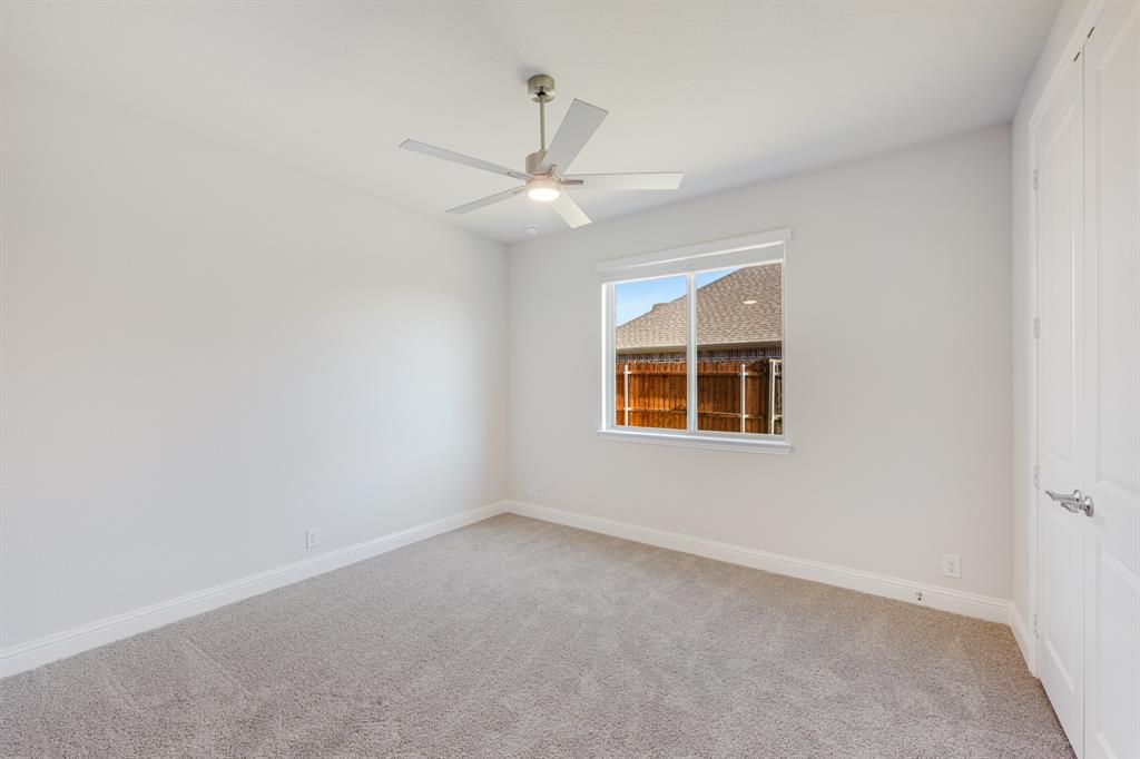 5622 Rowlan Row Midlothian, TX 76065 - Photo 19 of 35 an empty room with a window and ceiling fan