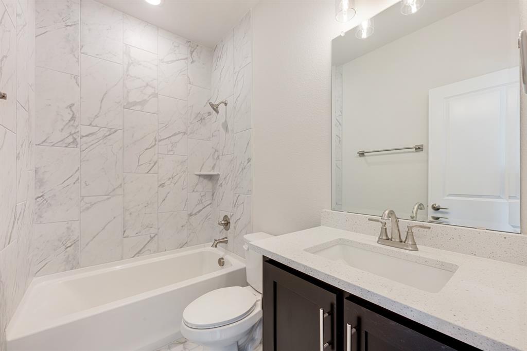 5622 Rowlan Row Midlothian, TX 76065 - Photo 28 of 35 a bathroom with a bathtub shower sink vanity mirror and toilet