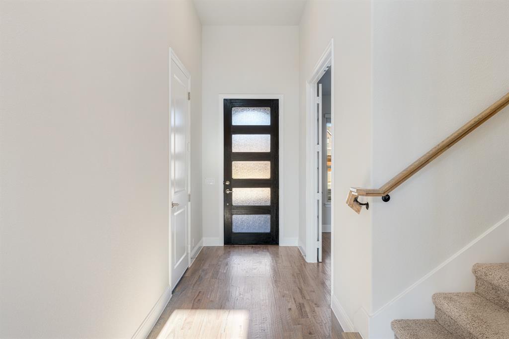 5622 Rowlan Row Midlothian, TX 76065 - Photo 5 of 39 a view of a hallway with wooden floor and closet