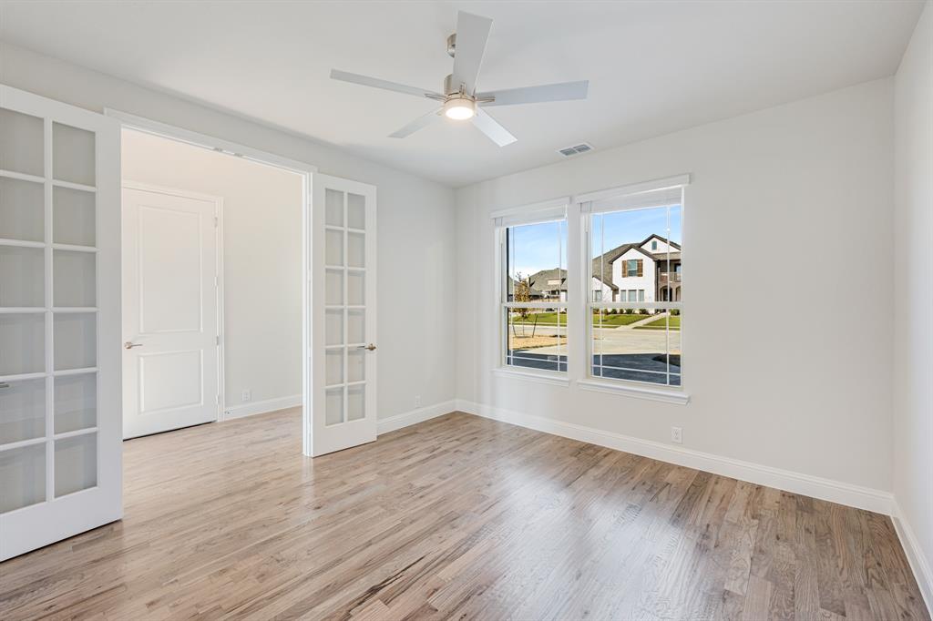 5622 Rowlan Row Midlothian, TX 76065 - Photo 6 of 35 an empty room with window and wooden floor