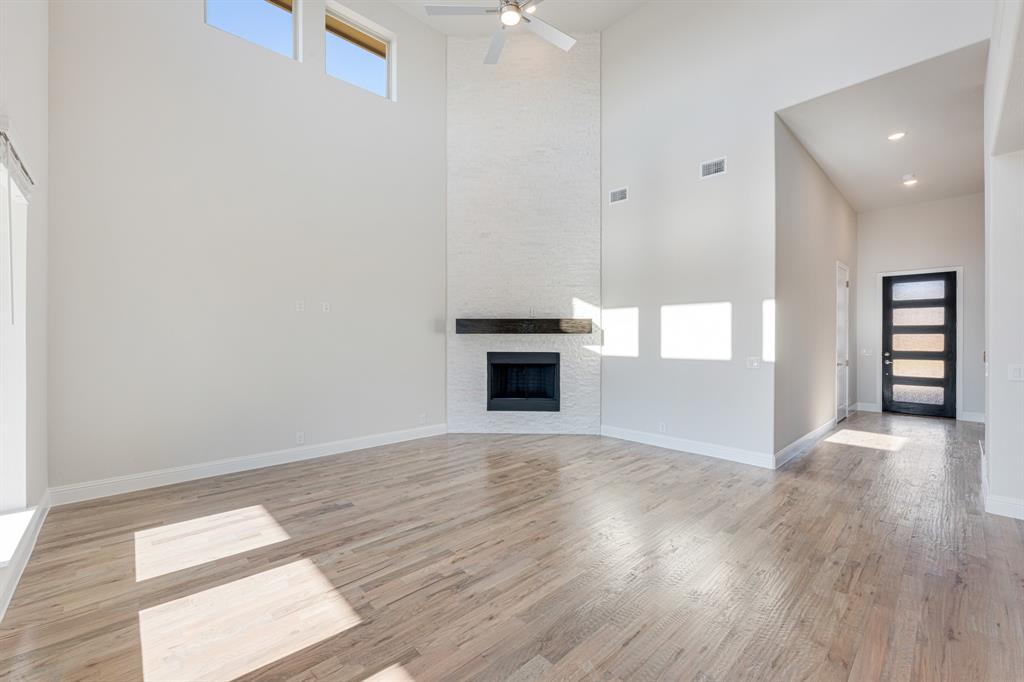 5622 Rowlan Row Midlothian, TX 76065 - Photo 8 of 39 a view of a livingroom with wooden floor and a kitchen space
