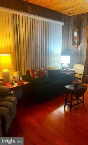 a living room with a bed furniture and a window