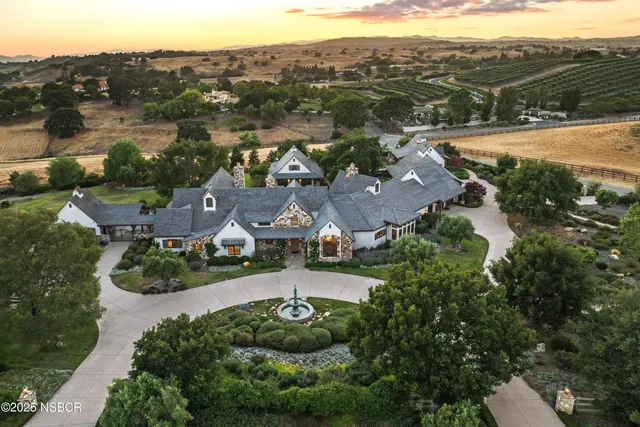 an aerial view of residential houses with outdoor space and river