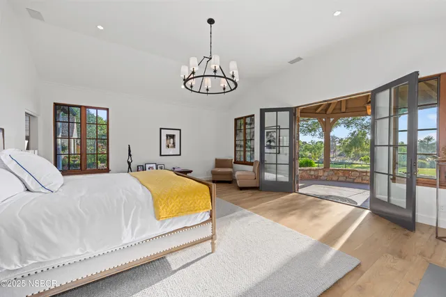 a spacious bedroom with a bed and a large window