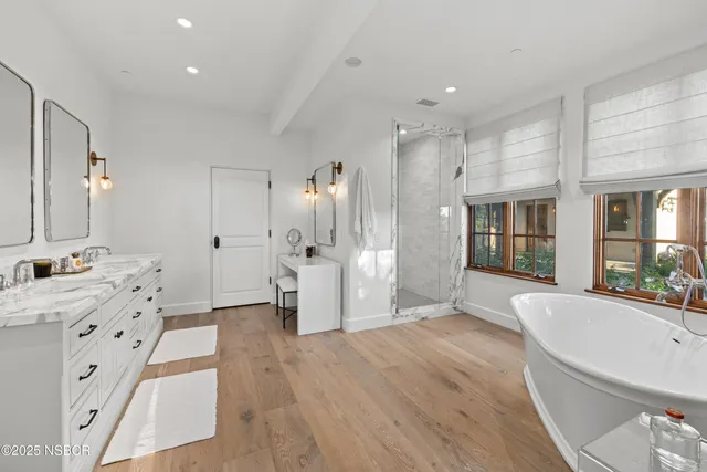 a large white kitchen with a large window
