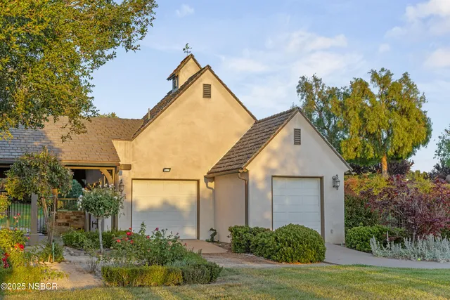 an aerial view of a house with outdoor space