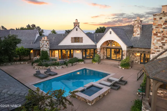 an aerial view of a house with a yard