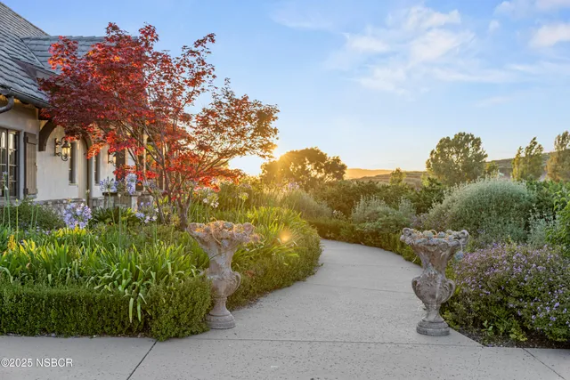 a livingroom with furniture a flat screen tv and a window