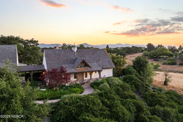 an aerial view of residential house with outdoor space and river
