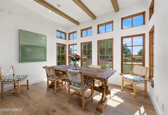 a view of a dining room with furniture window and outside view