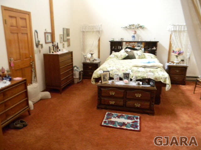 3455 G Road Clifton, CO 81520 - Photo 23 of 28 a bed sitting in a bedroom next to a window