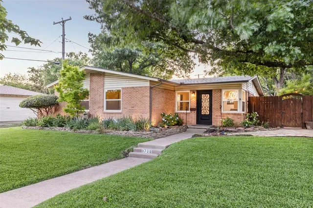 a front view of house with a garden and patio
