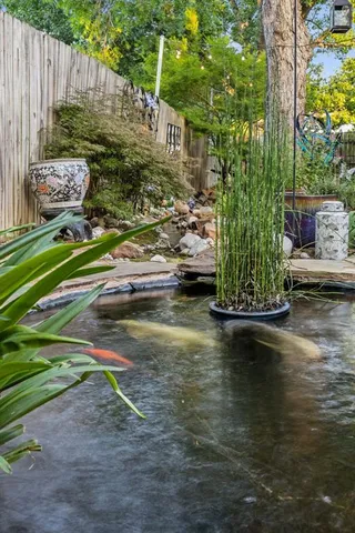 a view of a house with backyard and sitting area