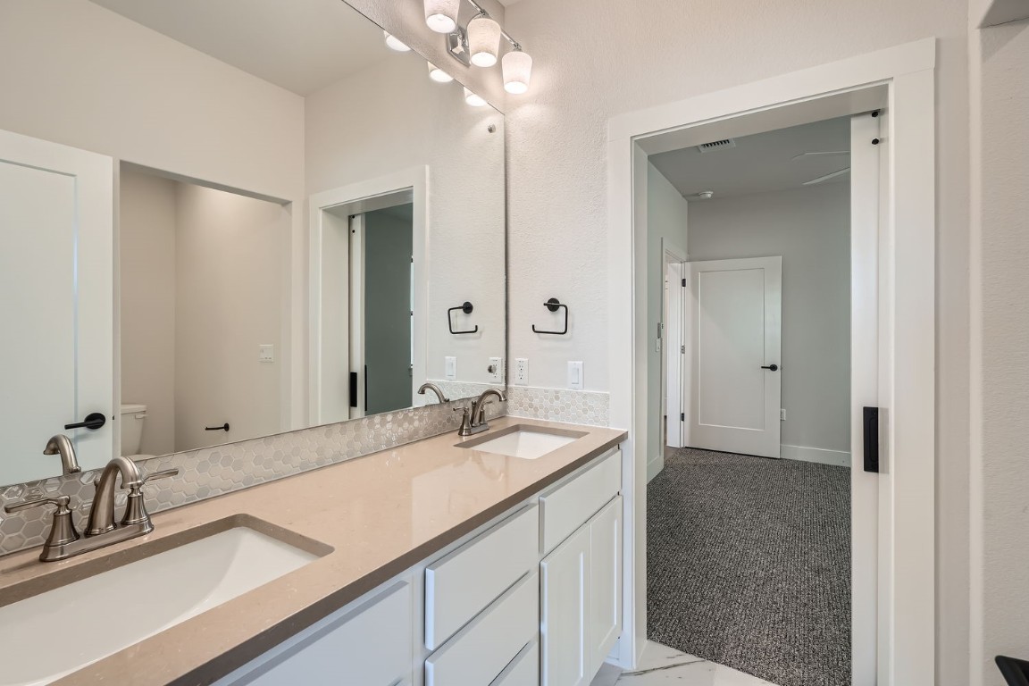 9033 Cattle Baron Path Austin, TX 78747 - Photo 11 of 28 a bathroom with a sink and a mirror