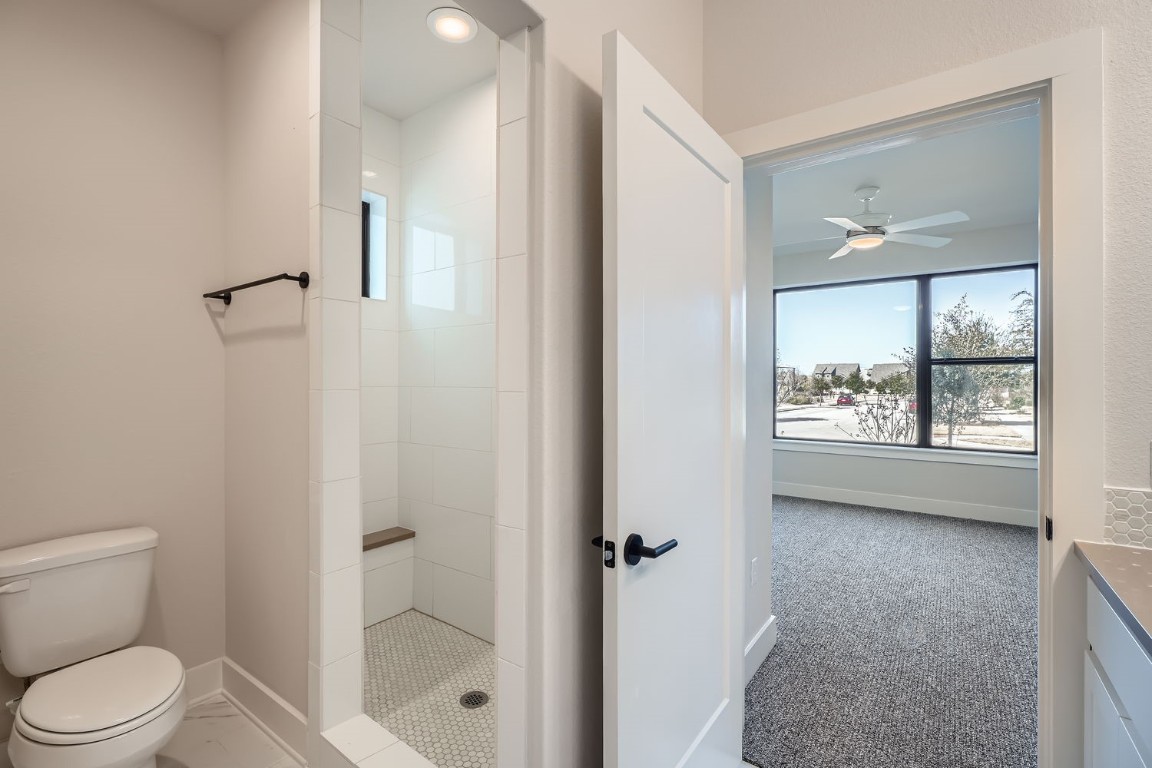 9033 Cattle Baron Path Austin, TX 78747 - Photo 12 of 28 a bathroom with a toilet a sink and shower