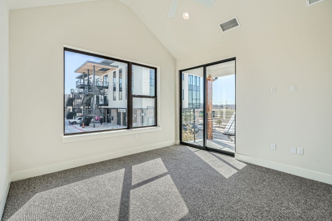9033 Cattle Baron Path Austin, TX 78747 - Photo 15 of 28 a view of a big room with windows and chandelier fan