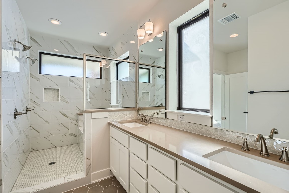9033 Cattle Baron Path Austin, TX 78747 - Photo 17 of 28 a bathroom with a shower sink and mirror