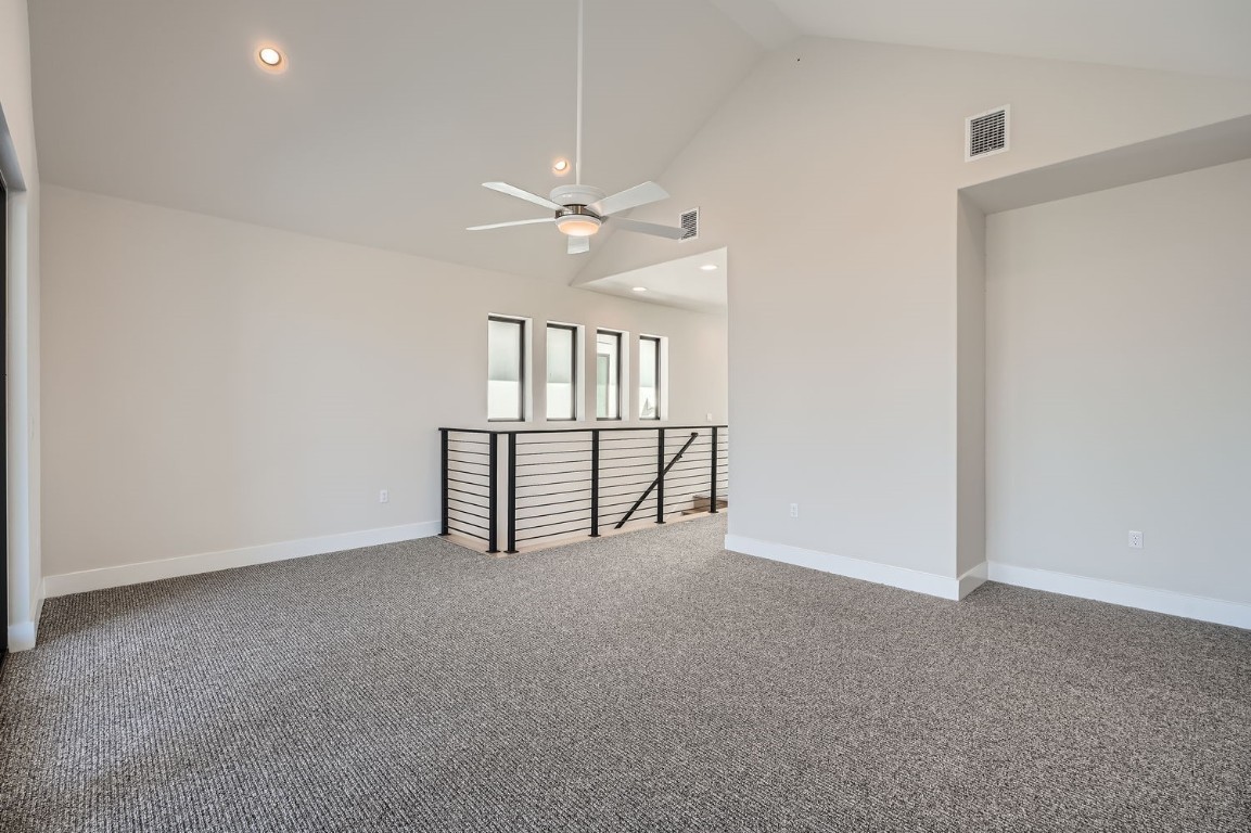 9033 Cattle Baron Path Austin, TX 78747 - Photo 23 of 28 an empty room with chandelier fan and windows