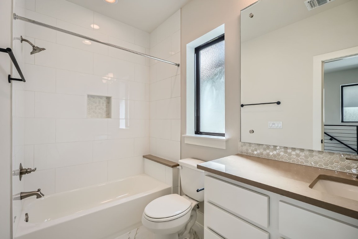 9033 Cattle Baron Path Austin, TX 78747 - Photo 25 of 28 a bathroom with a granite countertop sink a toilet and shower