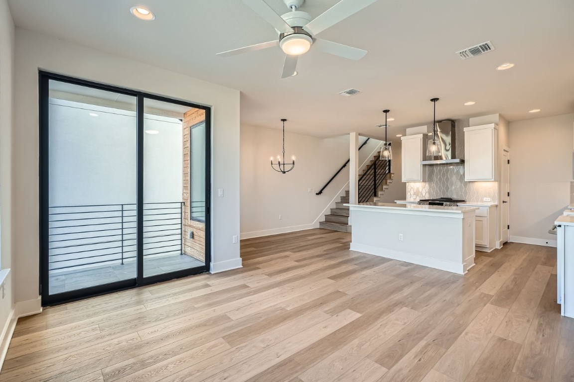 9033 Cattle Baron Path Austin, TX 78747 - Photo 5 of 28 a view of a hallway with stairs and a ceiling fan