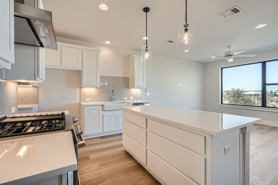 9033 Cattle Baron Path Austin, TX 78747 - Photo 7 of 28 a kitchen with a stove a sink and a refrigerator