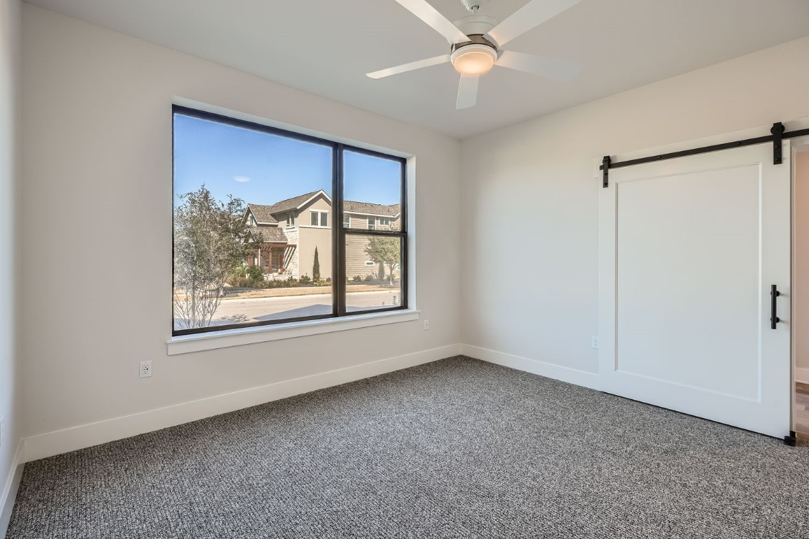 9033 Cattle Baron Path Austin, TX 78747 - Photo 8 of 28 an empty room with a window and a fan