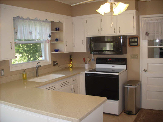 4051 Rotary Road Rockford, IL 61109 - Photo 5 of 9 a kitchen with stainless steel appliances a stove a sink a microwave and cabinets