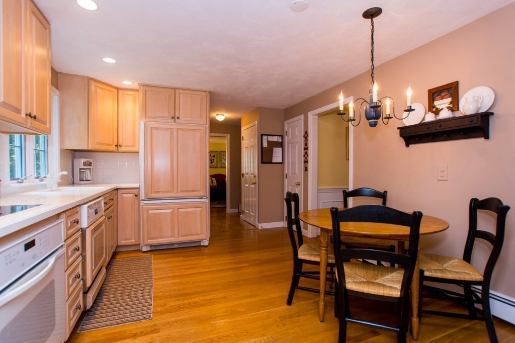 21 Lee Road Medfield, MA 02052 - Photo 3 of 30 a kitchen with stainless steel appliances kitchen island granite countertop a table chairs and a refrigerator