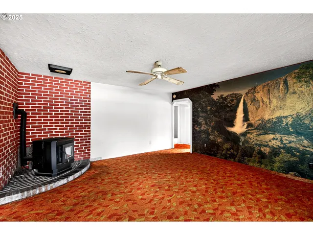 a view of an empty room with a fireplace