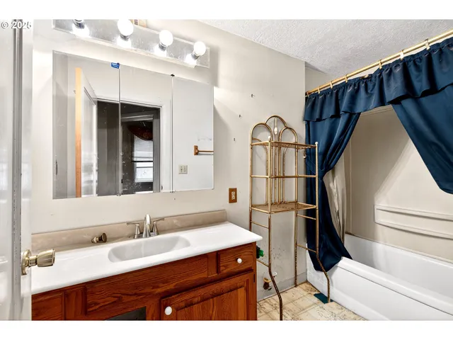 a bathroom with a sink a mirror and shower
