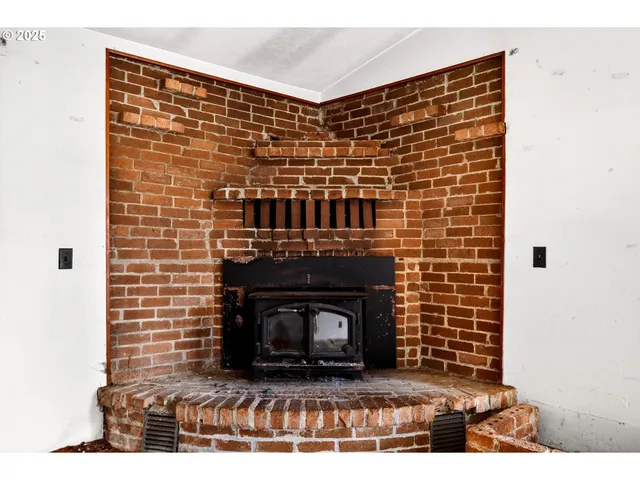 a view of empty room with fireplace