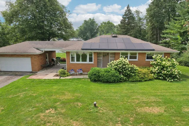 a front view of a house with a garden