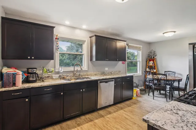a kitchen with lots of counter top space and dining table