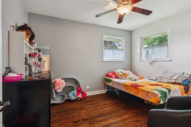 a bedroom with bed and a chandelier